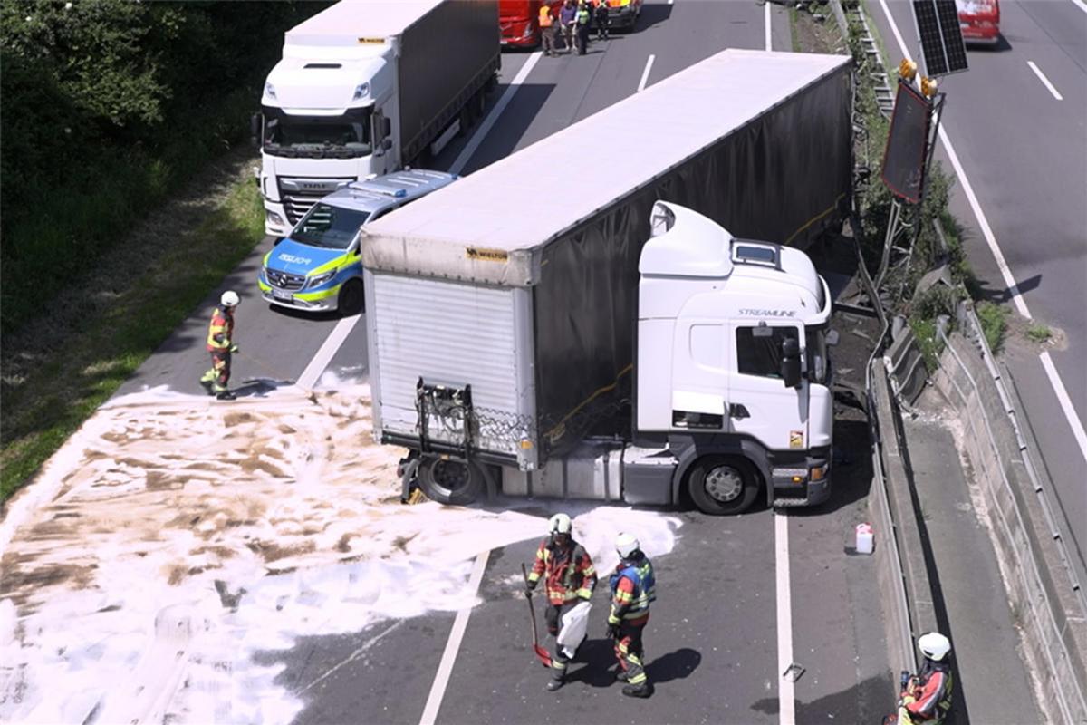 Burst truck tire pushes car against guardrail